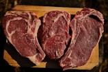 two pieces of steak on a cutting board