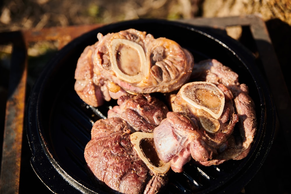 a close up of a grill with meat on it