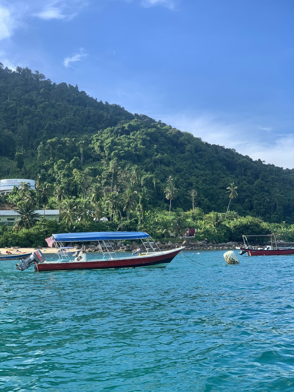 a group of boats floating on top of a body of water