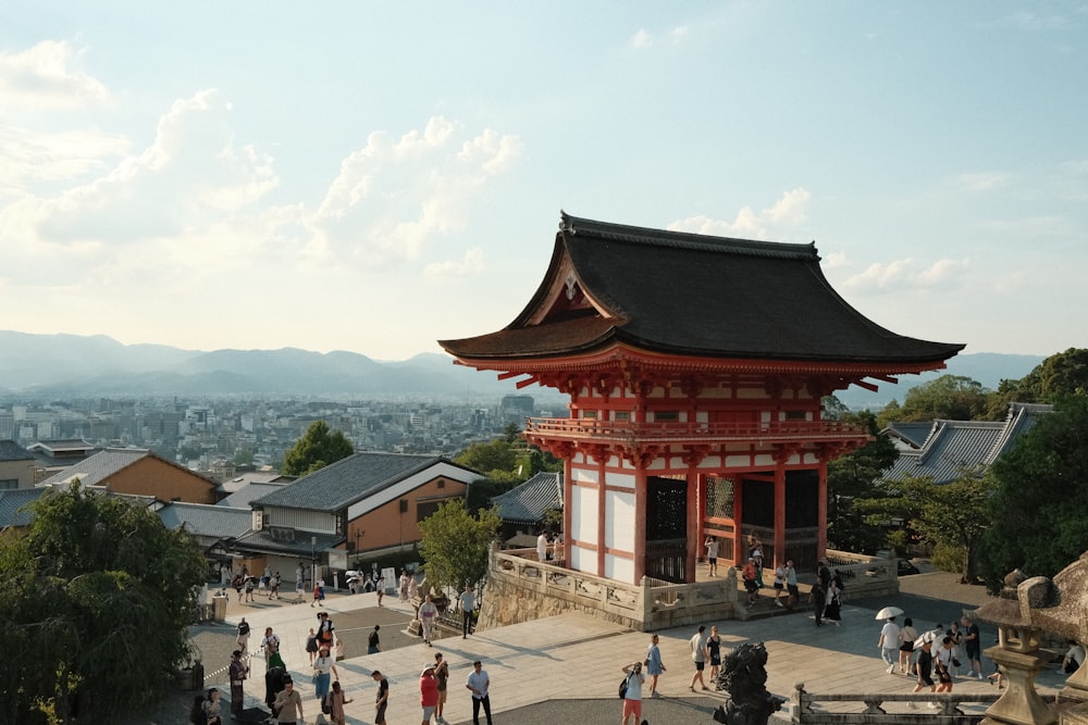 a group of people standing in front of a pagoda