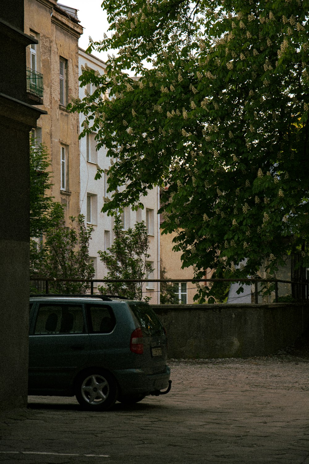 a car parked in a parking lot next to a tall building