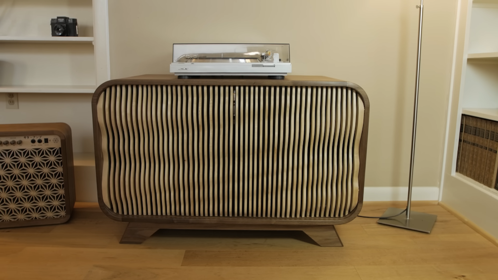 a record player sitting on top of a wooden cabinet