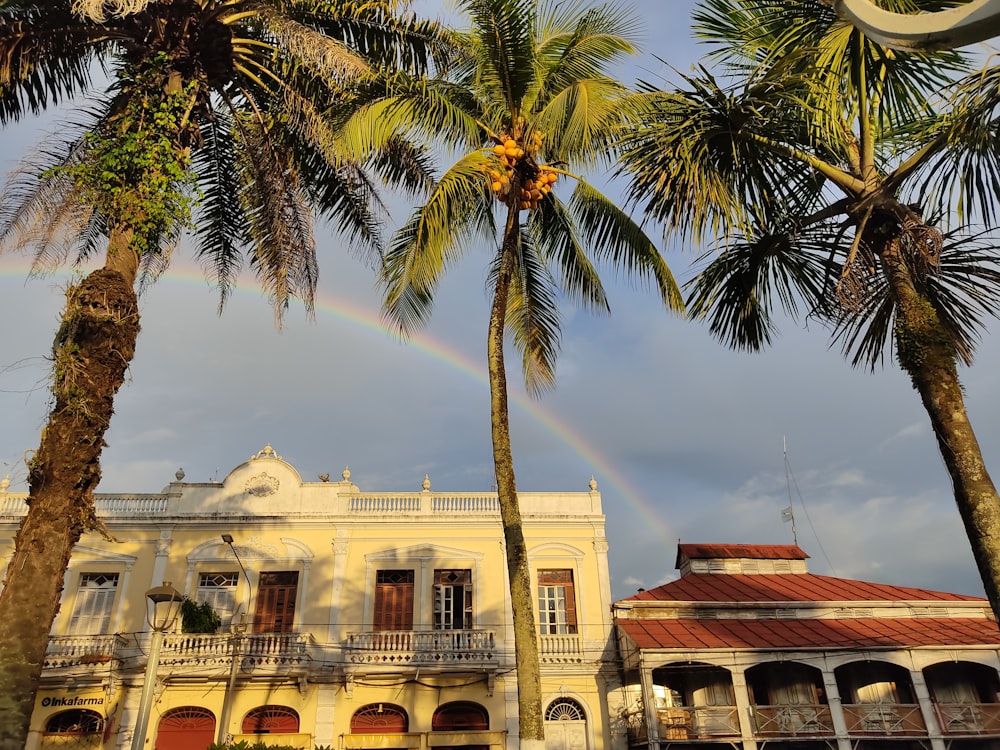 a rainbow shines in the sky over a building