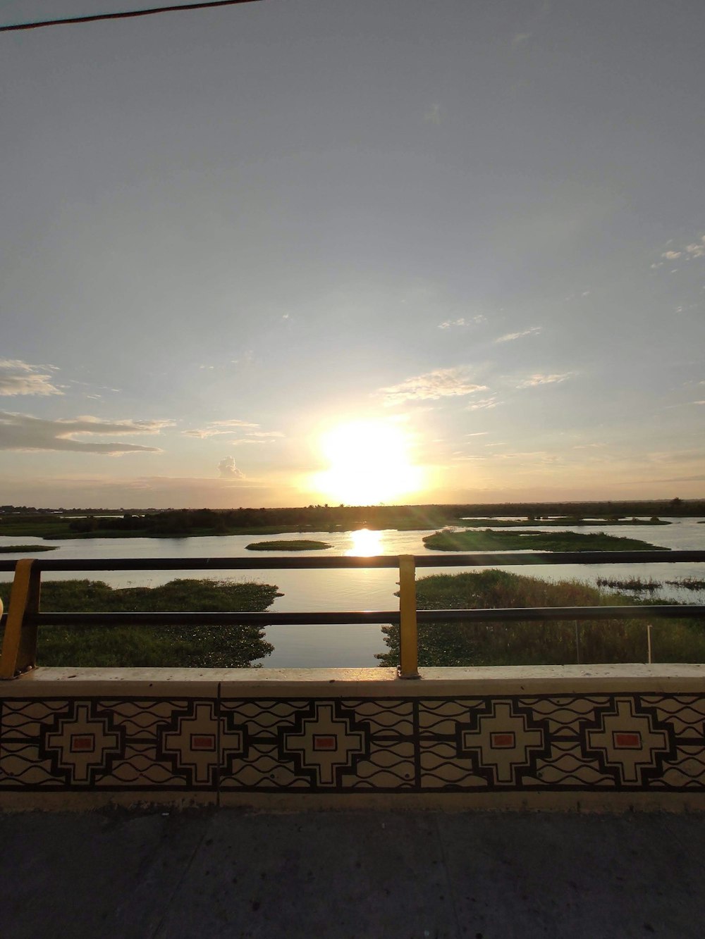 the sun is setting over a body of water