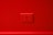 A red wall with a set of four electrical outlets in the center.