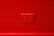 A red wall with a set of four electrical outlets in the center.