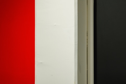 A conversion funnel graphic with sharp black, white, and red color scheme.