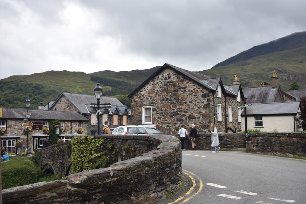 people walking down a street in a small village