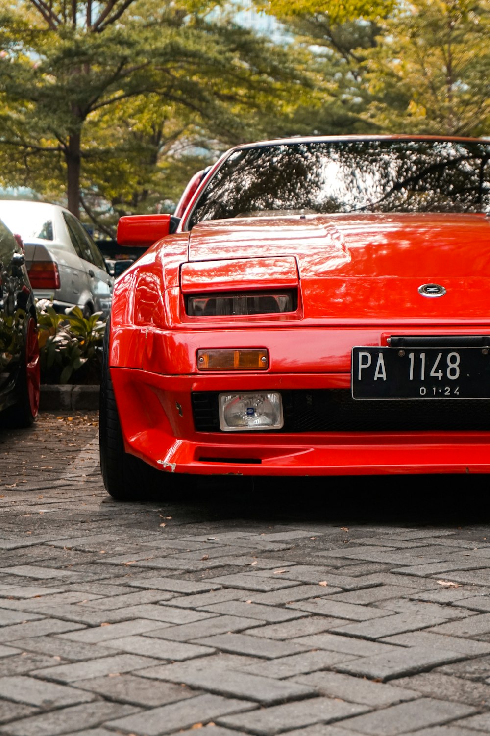 a red sports car parked in a parking lot