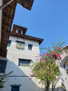 a tall white building with a clock on it's face
