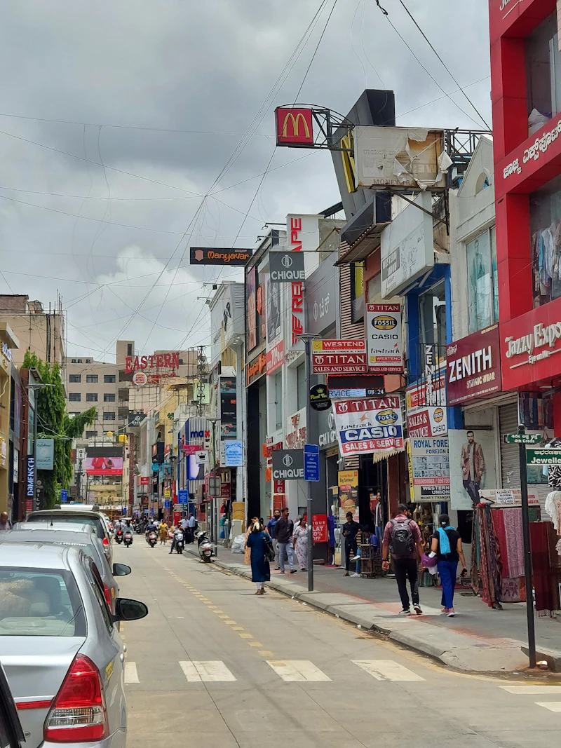 People and vehicles navigating a busy Bengaluru street