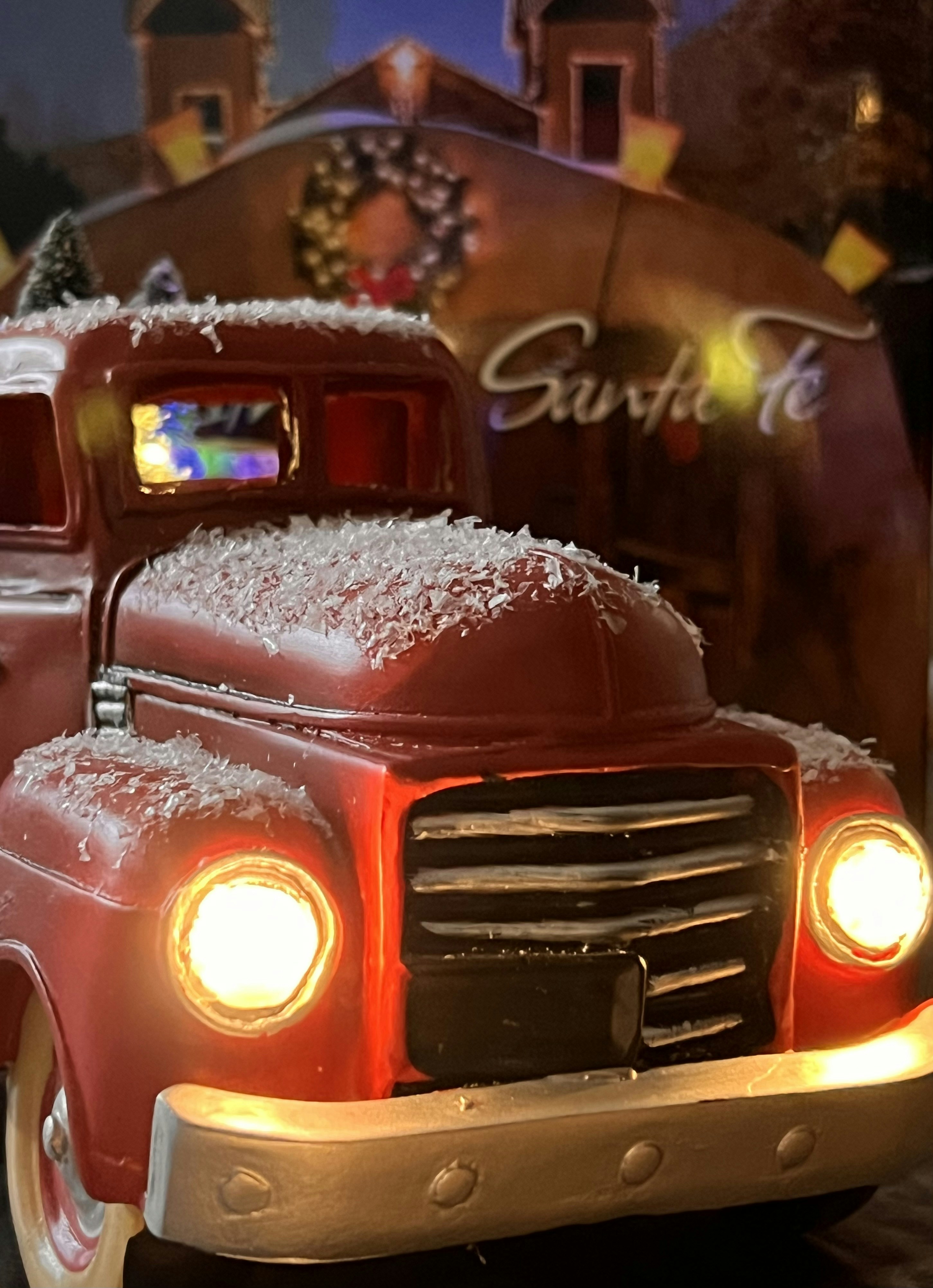 A red truck with a christmas tree in the back photo Free Santa fe