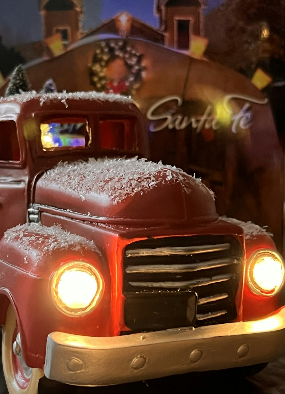 a red truck with a christmas tree in the back