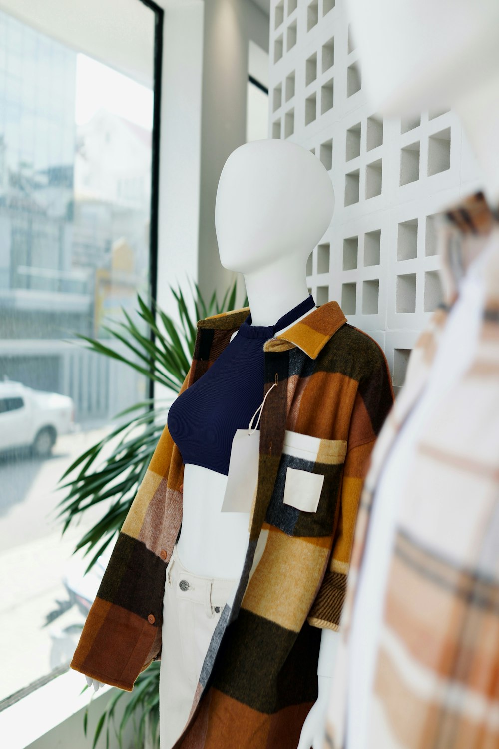 a display of clothing on a mannequin in front of a window