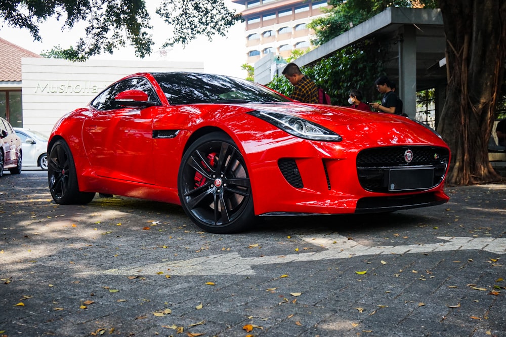 a red sports car parked on the side of the road