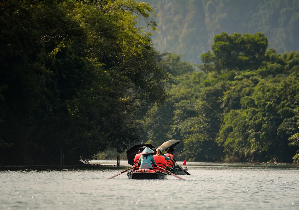 a group of people riding on top of a boat on a river