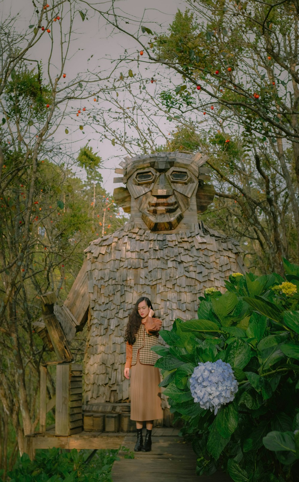 a woman standing in front of a stone building