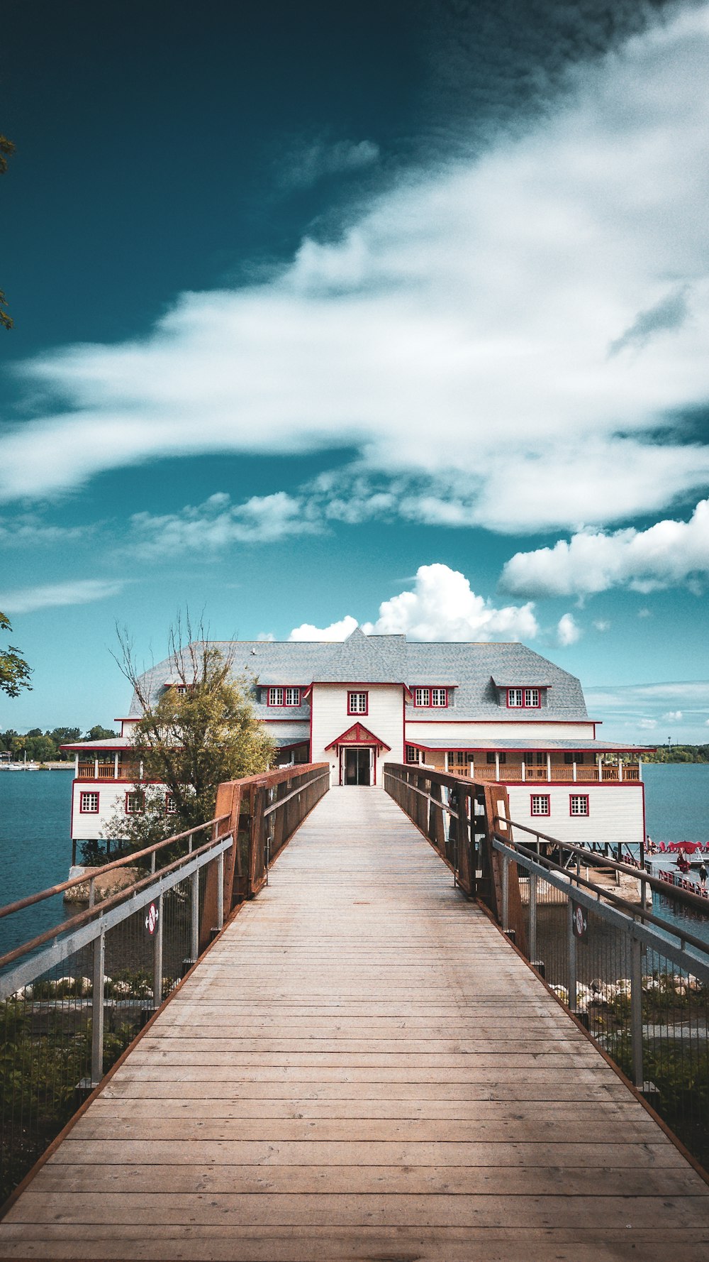 a wooden walkway leading to a white building