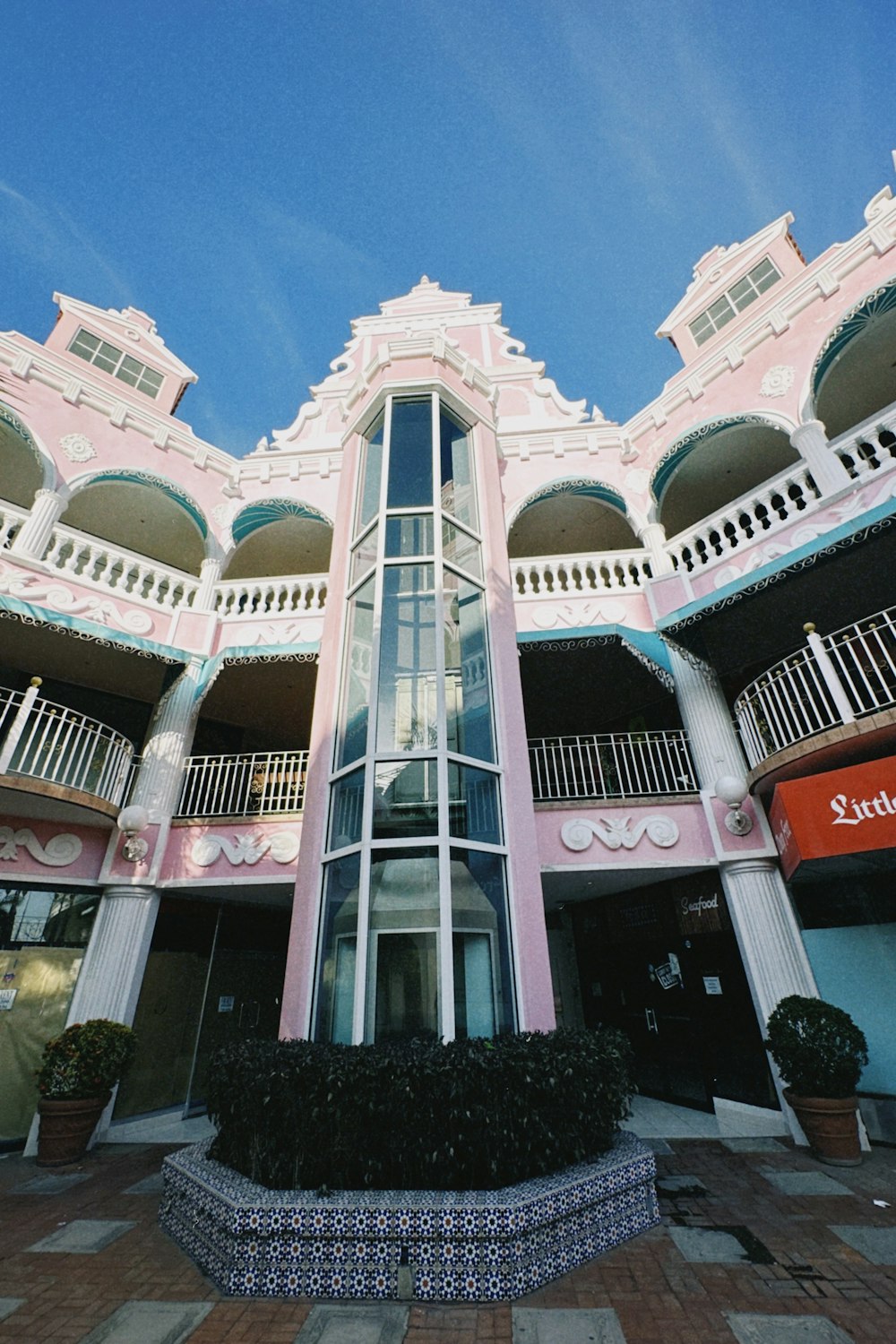 a pink and white building with balconies and balconies