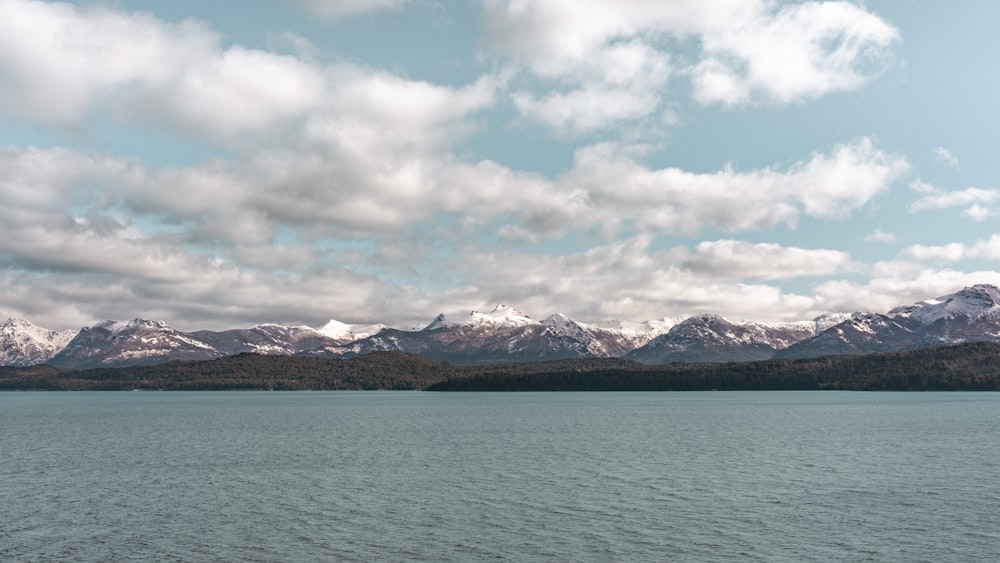 a large body of water with mountains in the background