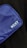 A close-up view of a blue fabric bag with the brand name 'NZXT' printed in white text on it. The bag is positioned against a dark background, showcasing its texture and color.