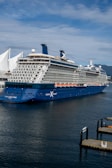 a large cruise ship in the water next to a dock