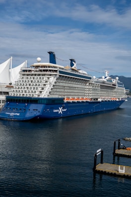 a large cruise ship in the water next to a dock