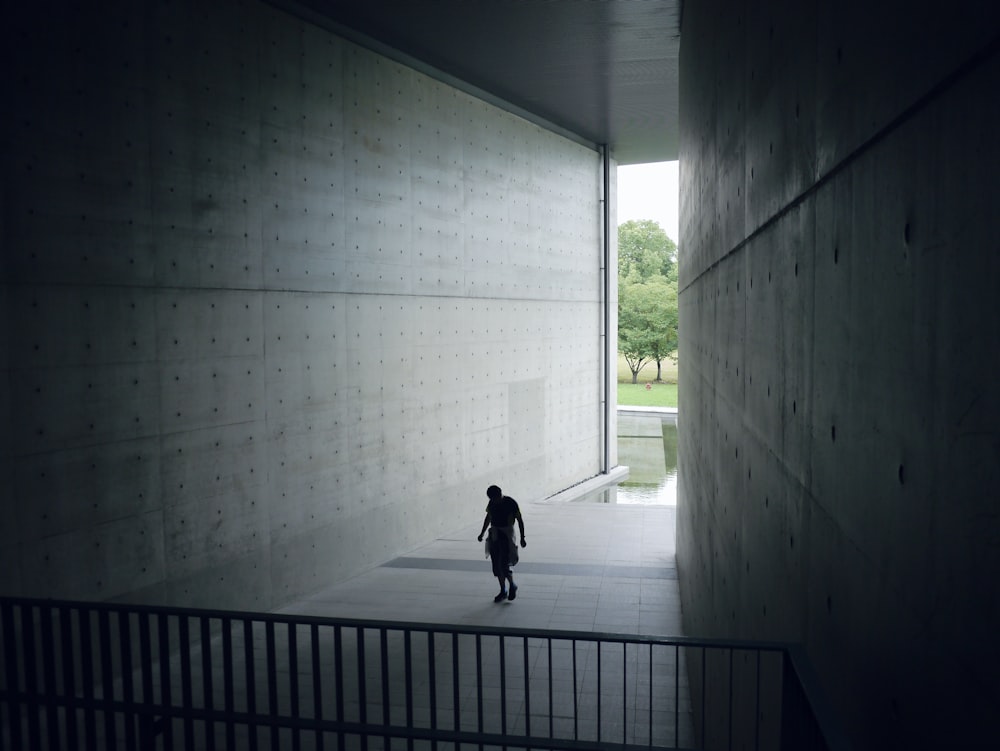 a person standing in a room with a wall