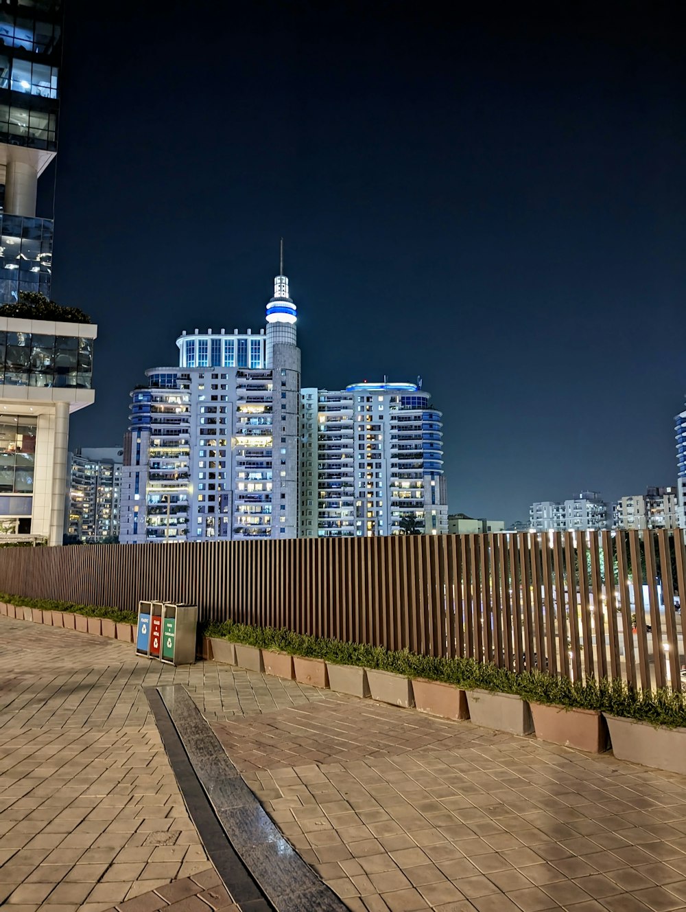 a bench sitting in front of a tall building