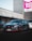 A sleek black Honda Civic Type R is parked in a commercial area. The car's front end features a prominent red Honda emblem and sporty design elements. In the background, there is a large sign with the words 'South Flatz' in bold pink and white letters against an industrial building.
