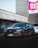 A sleek black Honda Civic Type R is parked in a commercial area. The car's front end features a prominent red Honda emblem and sporty design elements. In the background, there is a large sign with the words 'South Flatz' in bold pink and white letters against an industrial building.