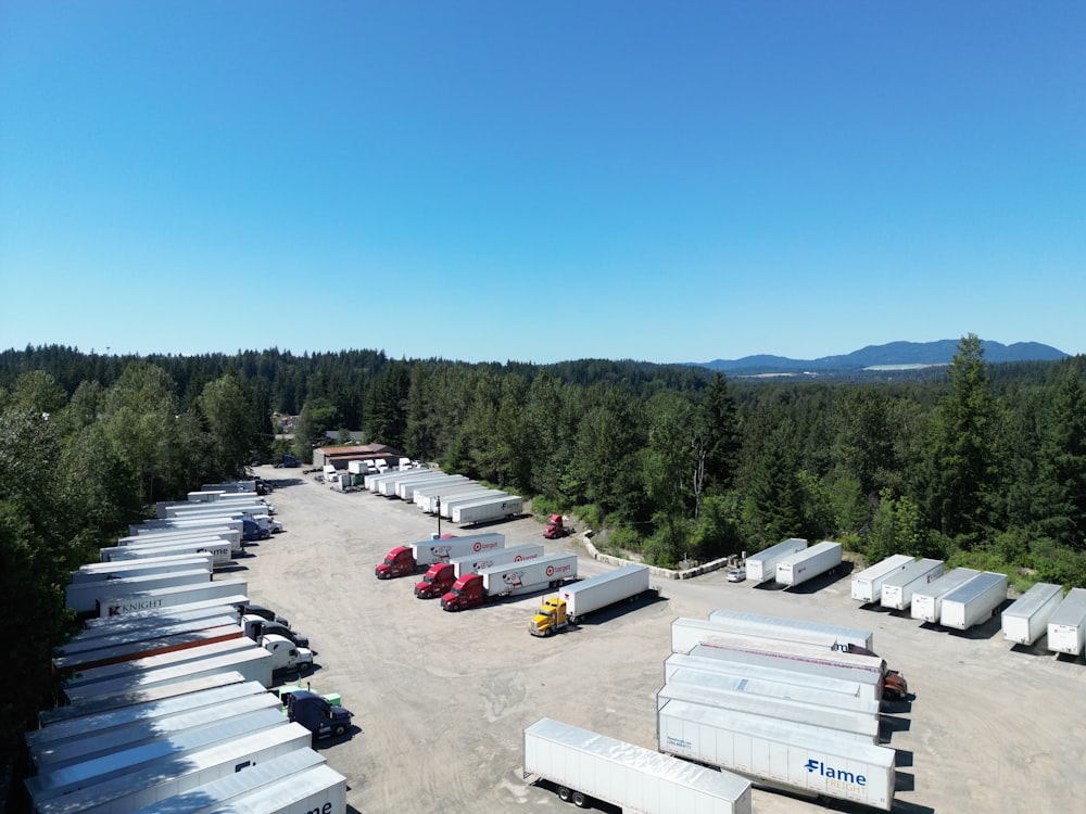 a parking lot filled with lots of trucks and trailers