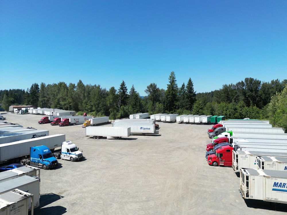a parking lot filled with lots of trucks and trailers