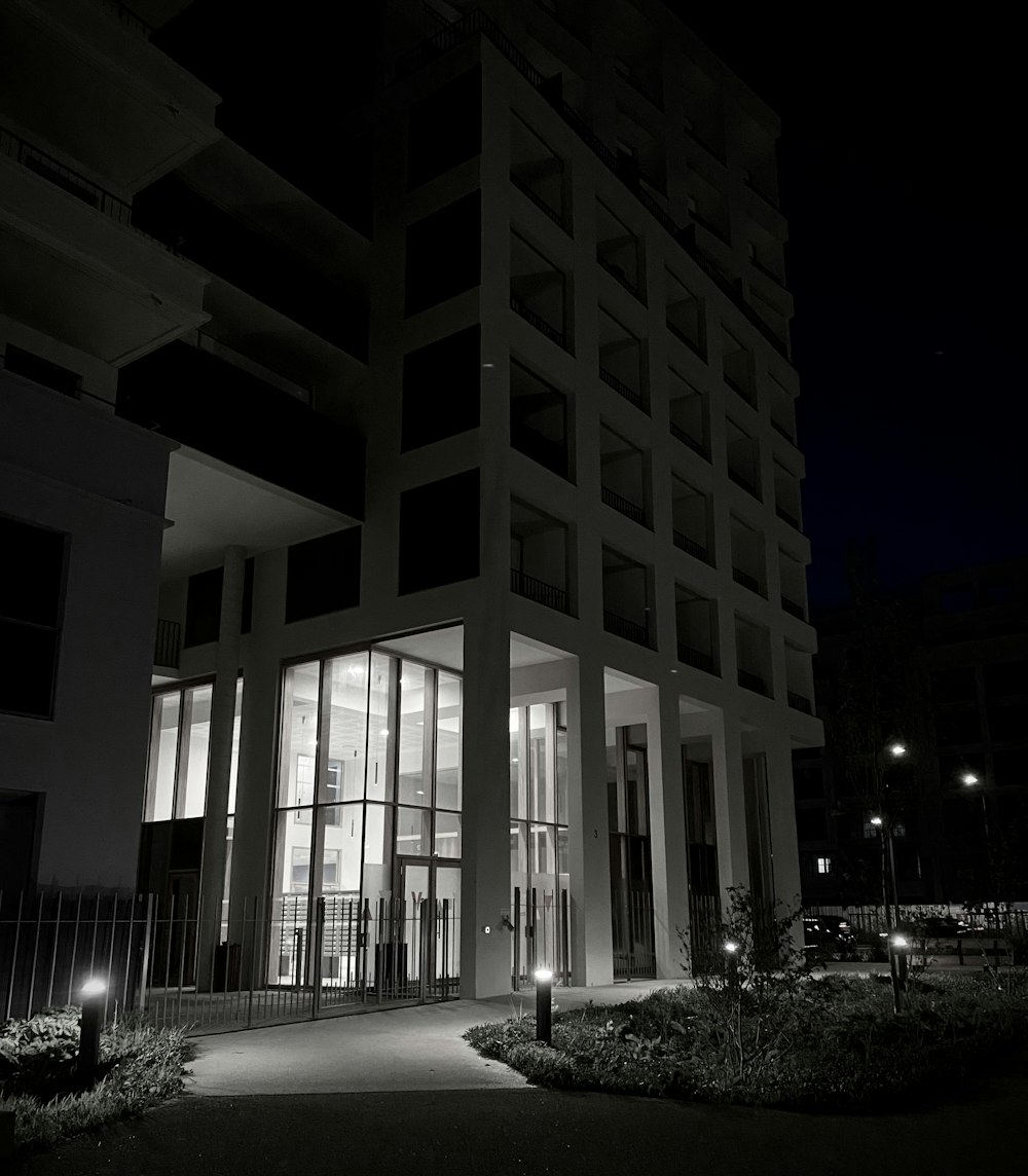 a black and white photo of a building at night