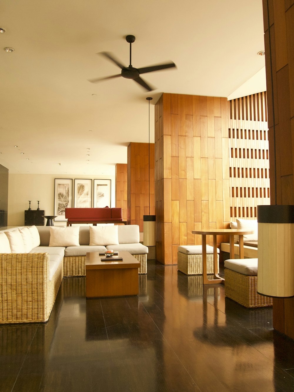 a living room filled with furniture and a ceiling fan