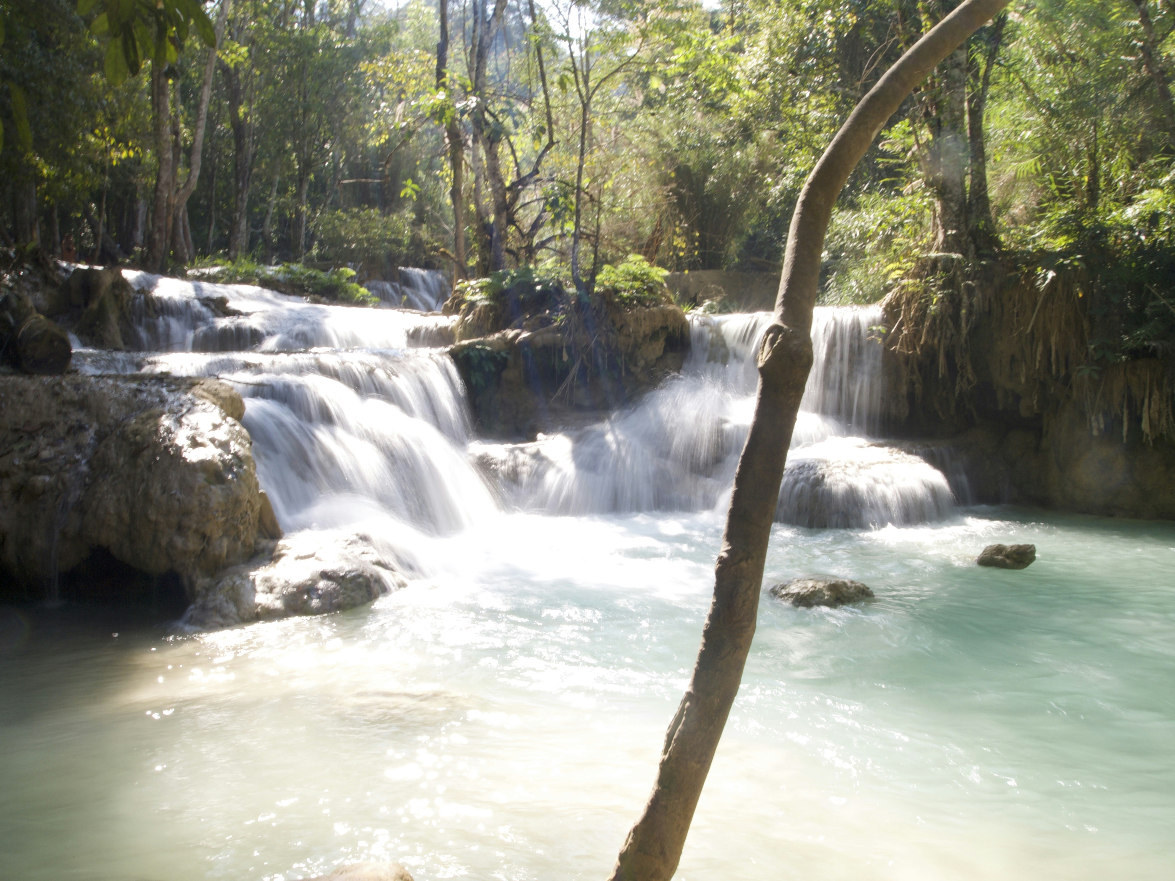 a small waterfall in the middle of a forest, Beautiful Waterfall in Luang Prabang, Laos