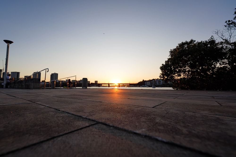 the sun is setting over the city skyline