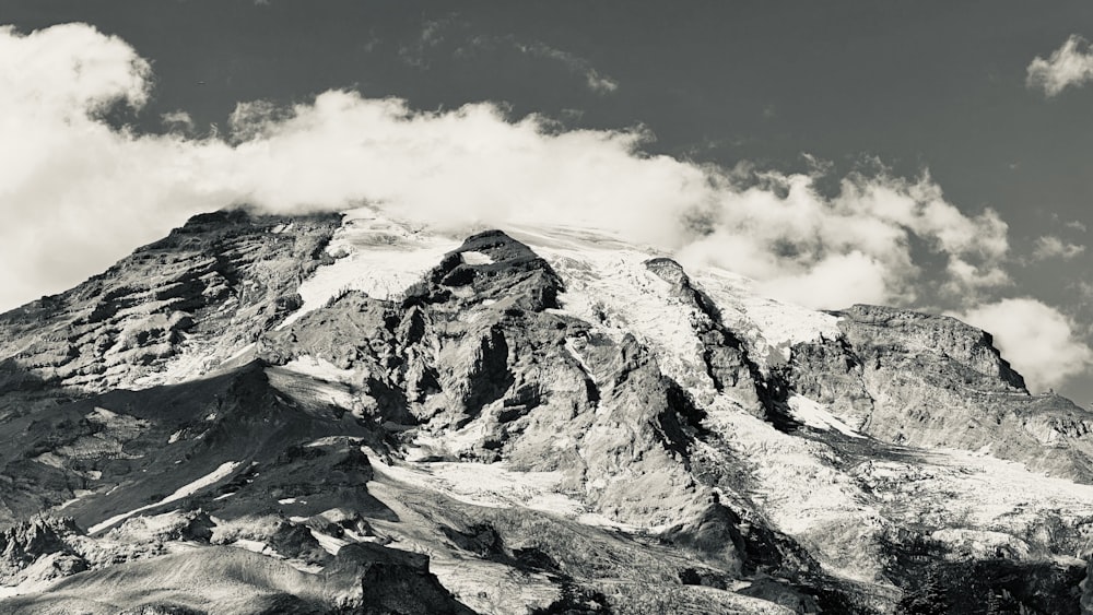 a black and white photo of a snow covered mountain