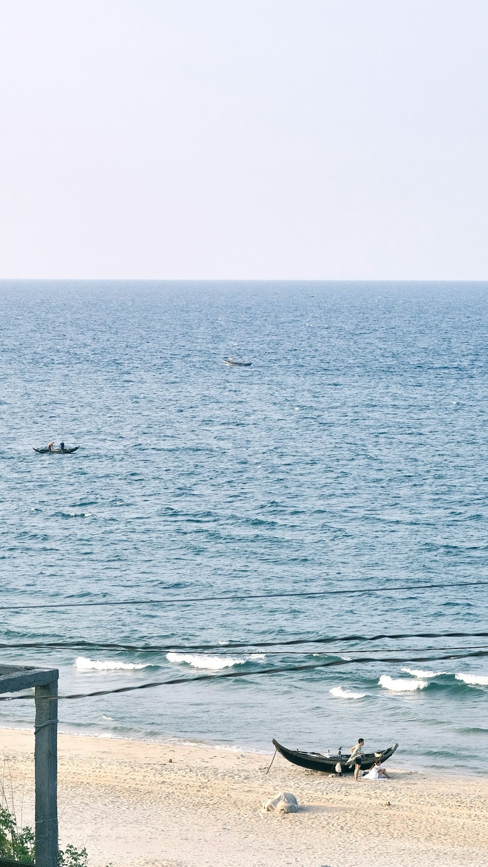 a couple of boats that are sitting in the sand