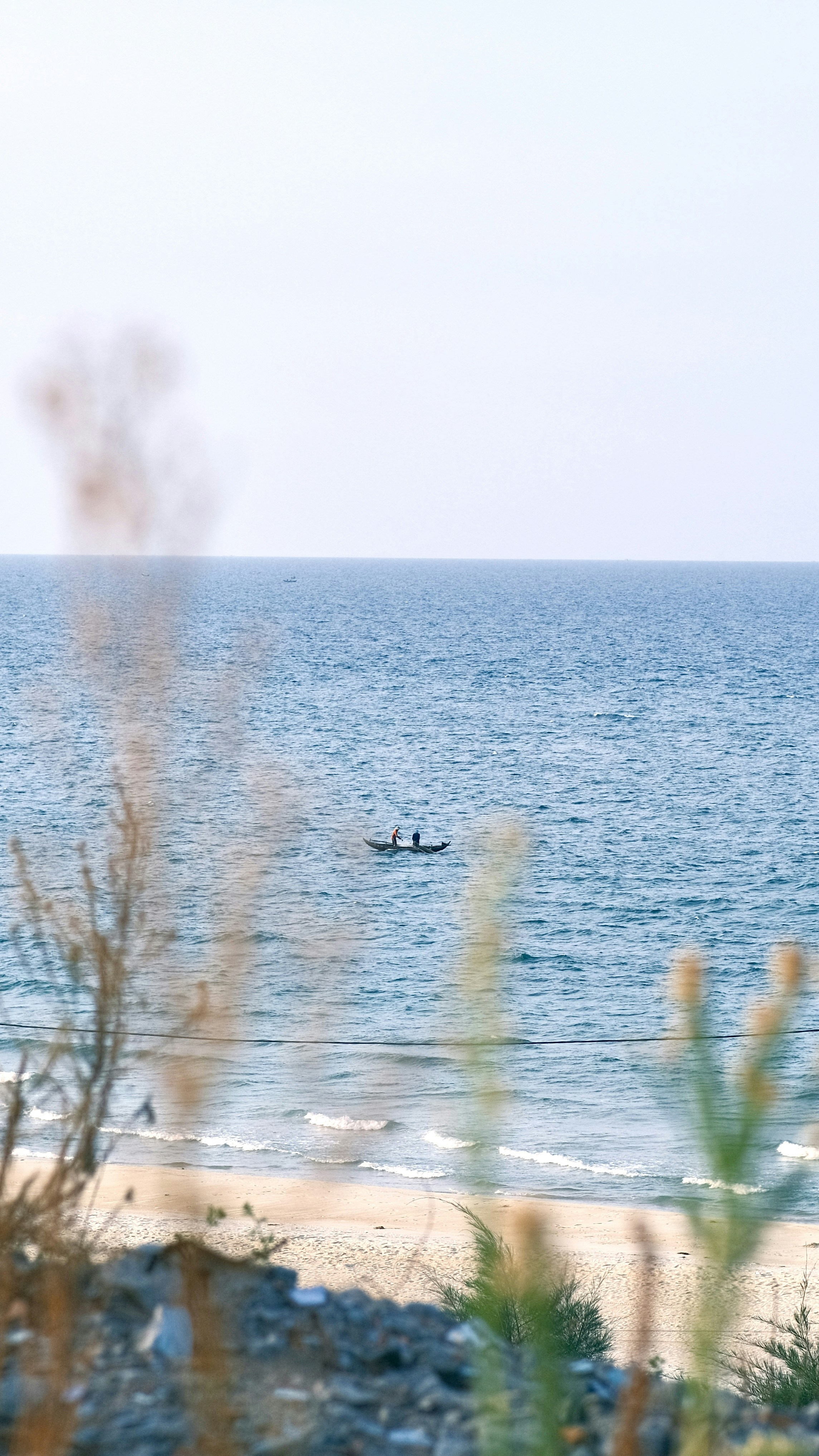 a couple of people in a small boat in the ocean