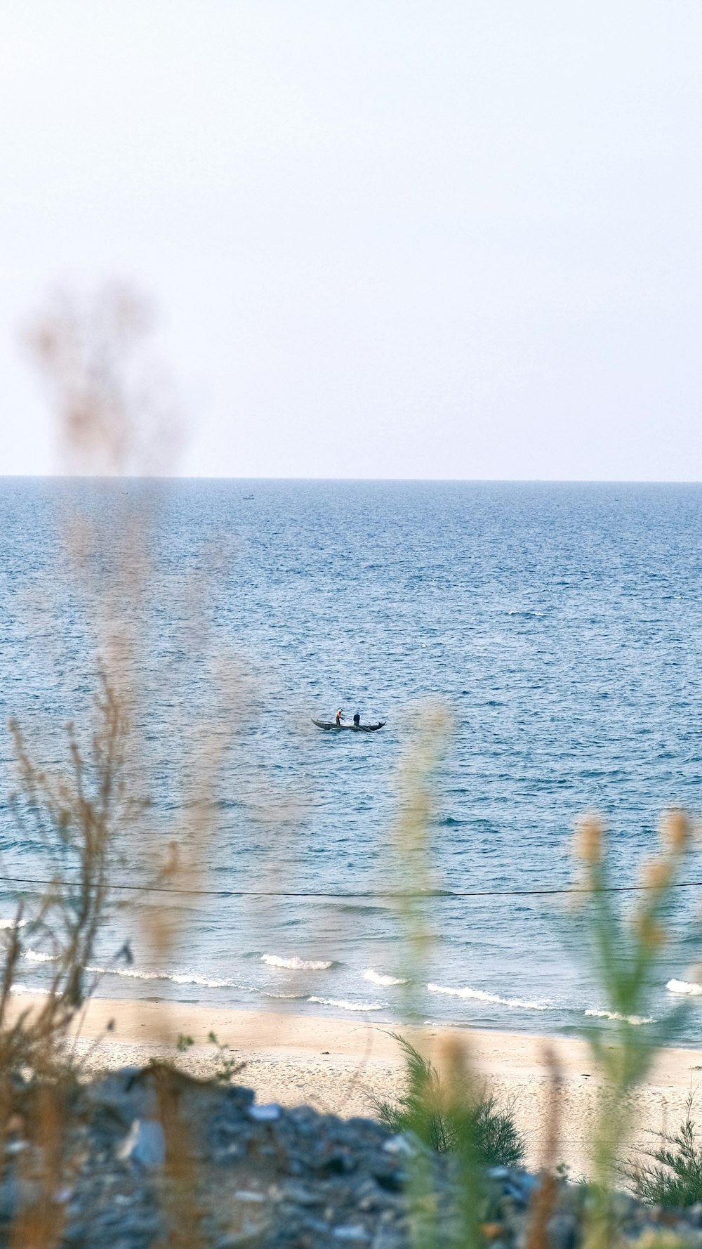 a couple of people in a small boat in the ocean