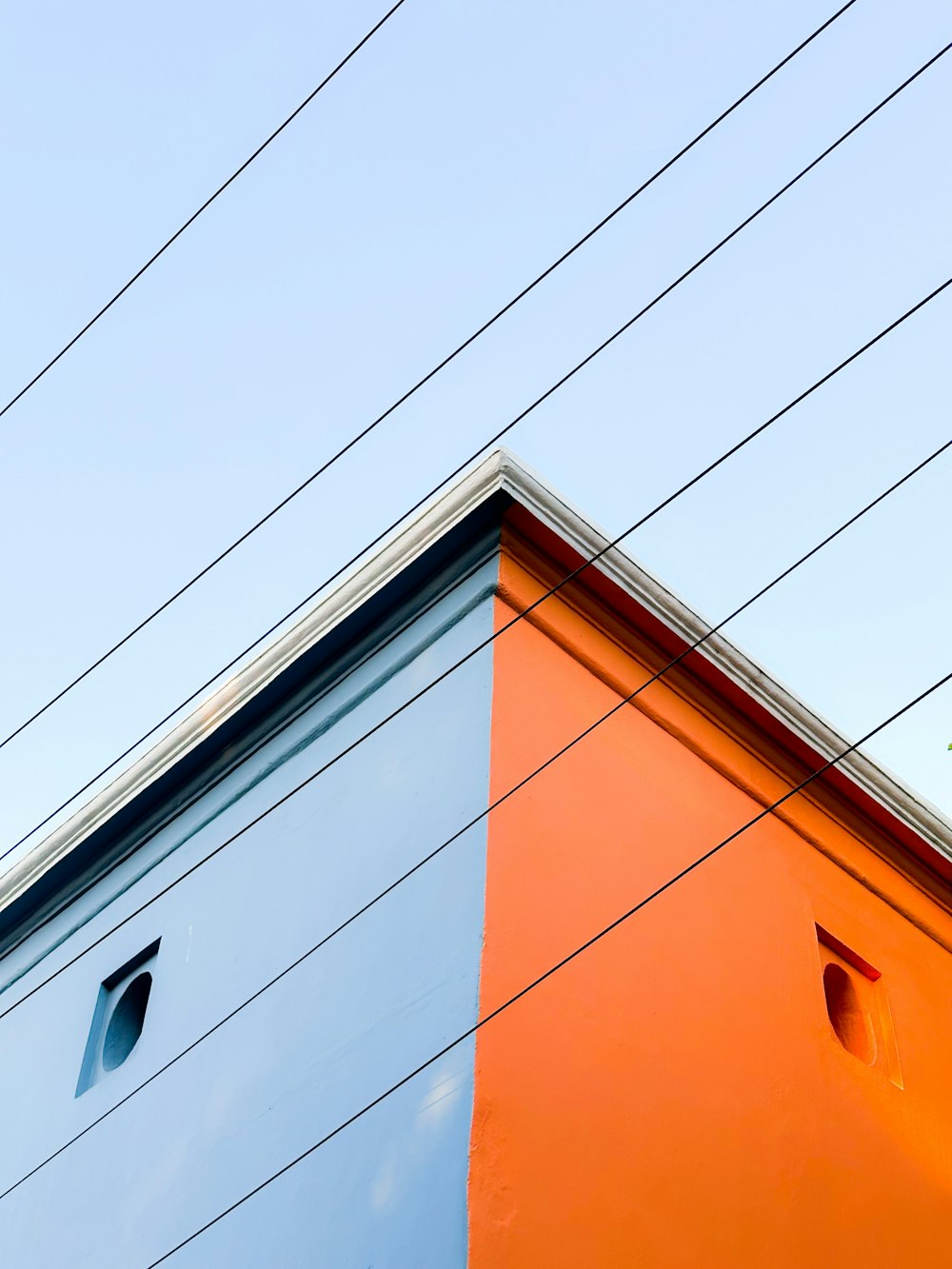 an orange and blue building with power lines in the background