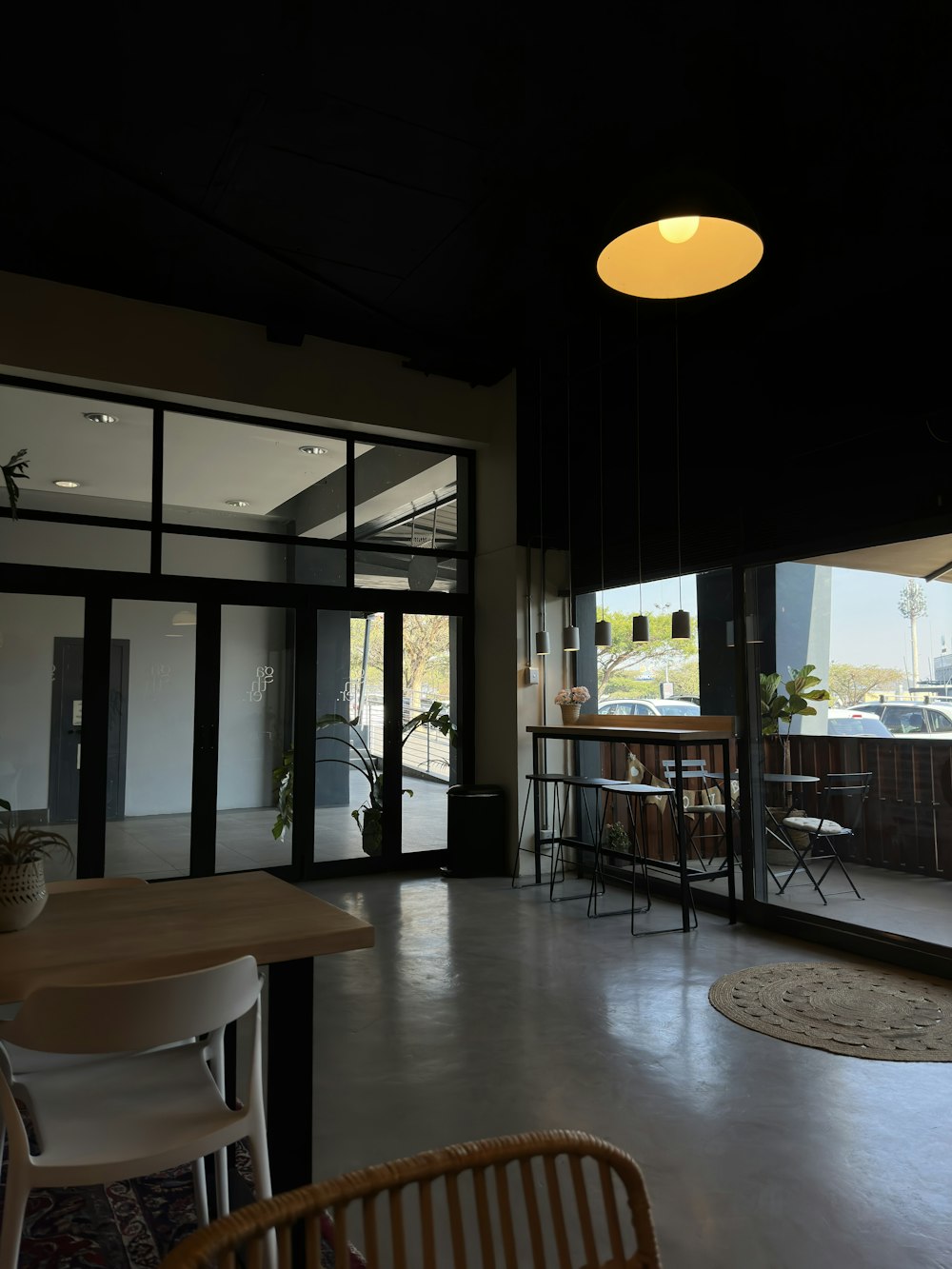 a room with a table, chairs, and a light hanging from the ceiling