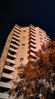 a tall building with balconies on the top of it