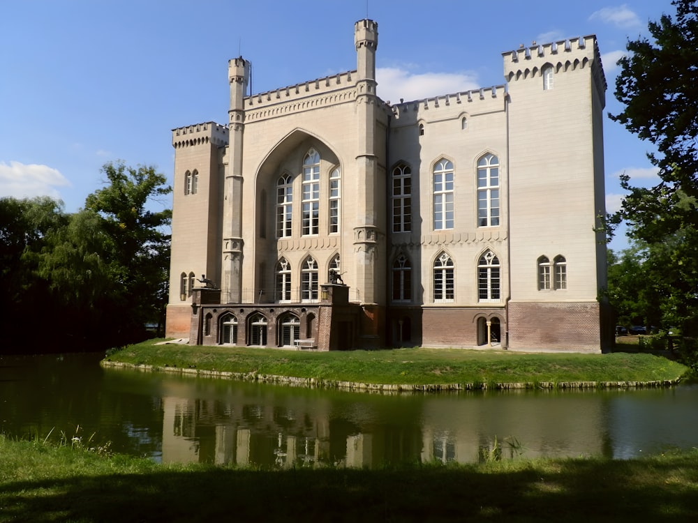 a castle like building with a pond in front of it