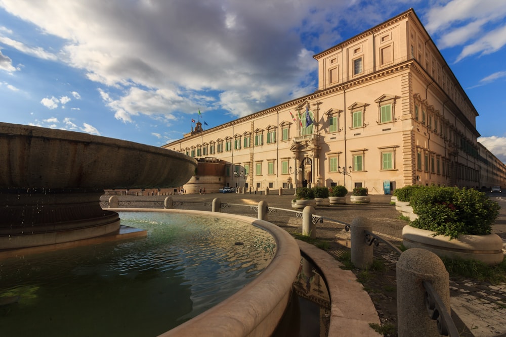 a large building with a fountain in front of it