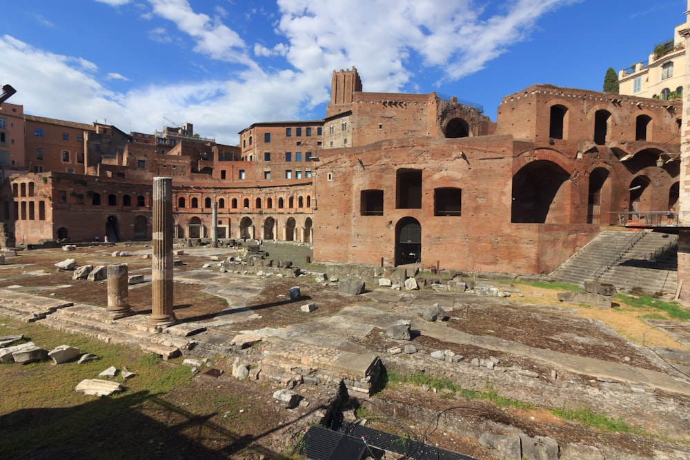 the ruins of a roman city with a blue sky in the background