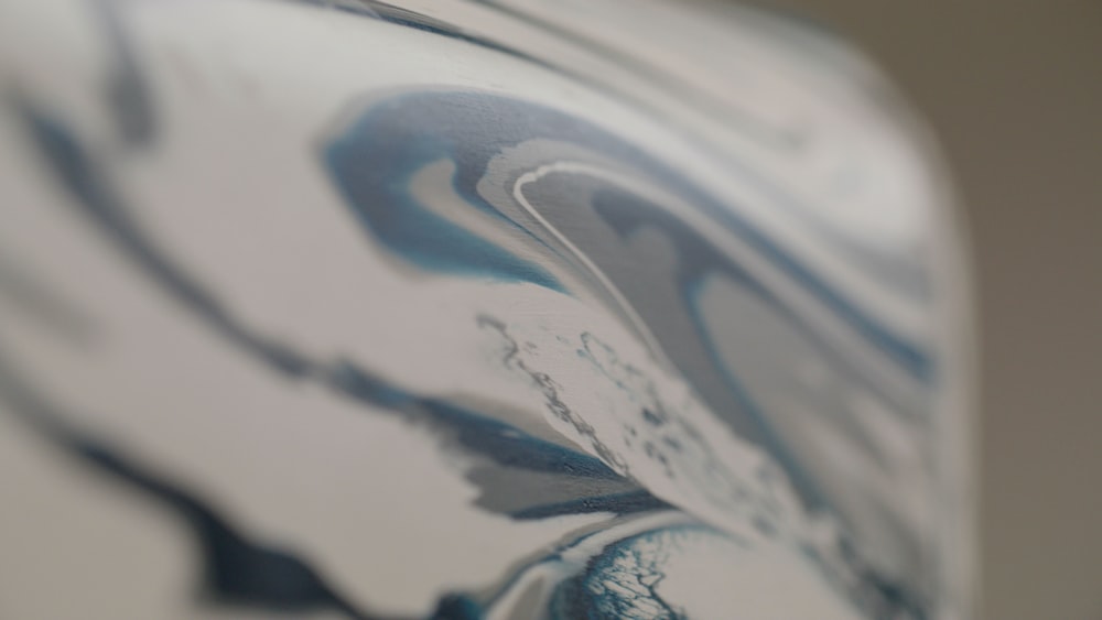 a close up of a blue and white vase
