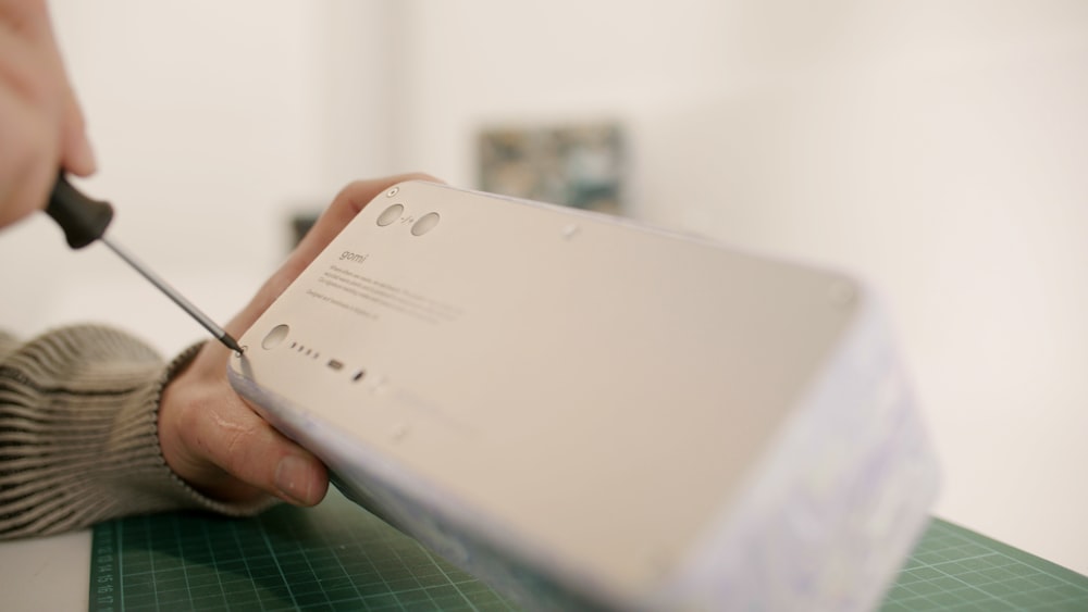 a person cutting a piece of paper with a pair of scissors