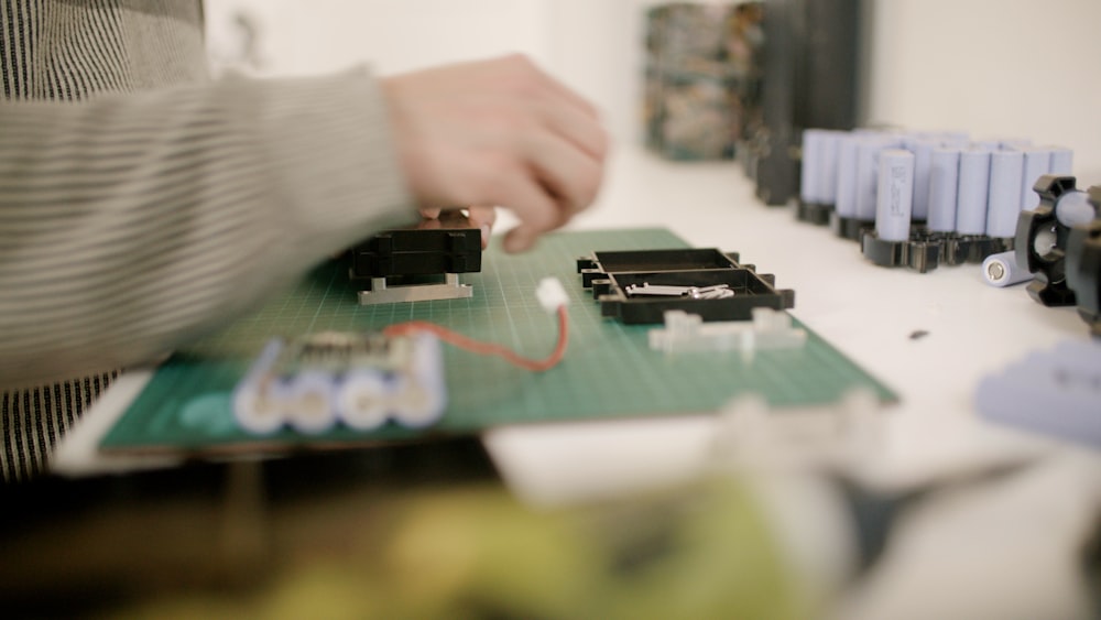 a person is working on some electronics on a table